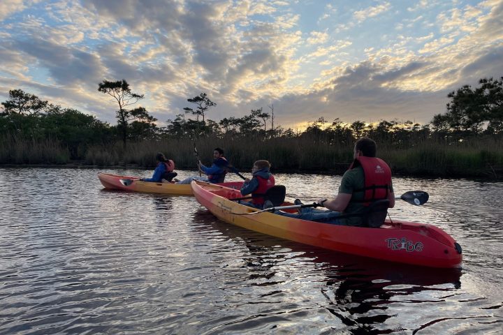 a group of people in a small boat in a body of water