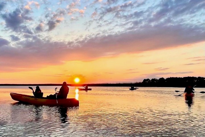 a group of people in a boat on a body of water