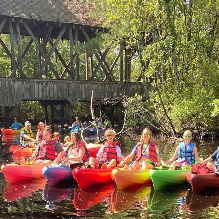 a group of people riding on the back of a boat