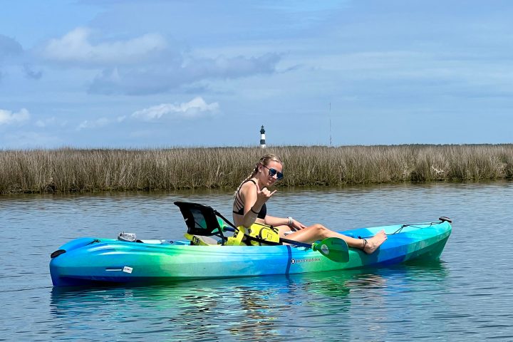 a person riding on the back of a boat in the water