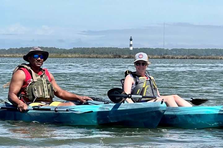 a group of people rowing a boat in the water