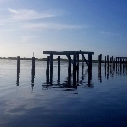 a close up of a pier next to a body of water