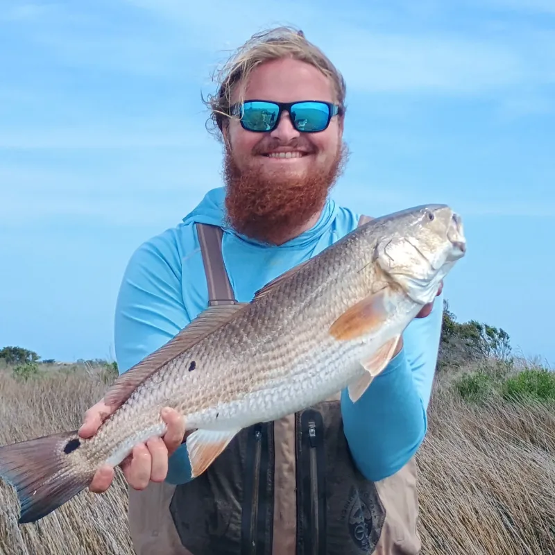 7576564089900751205_aae12c a man holding a fish